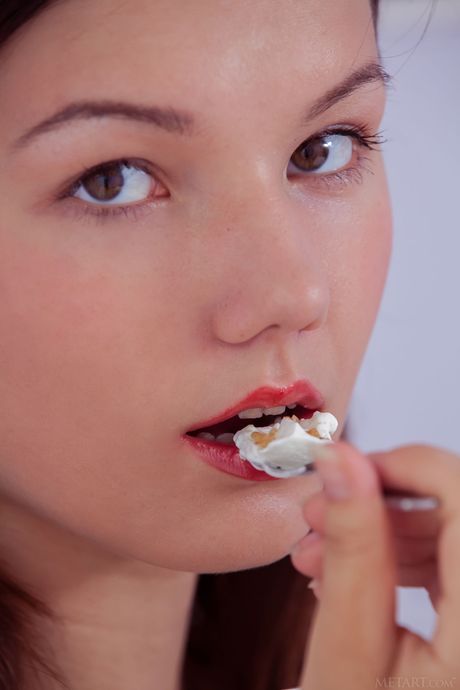 Bashful teen Iva removes her bikini to pose nude on a beach towel