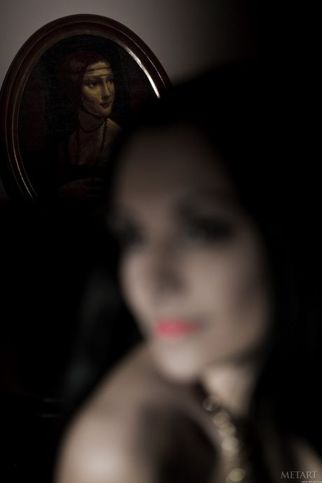 Slender teen Carmen B removes a black leather dress to pose nude