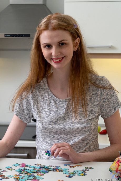 Slim teen Linda Maers takes off her pantyhose and rubs her pussy in the kitchen