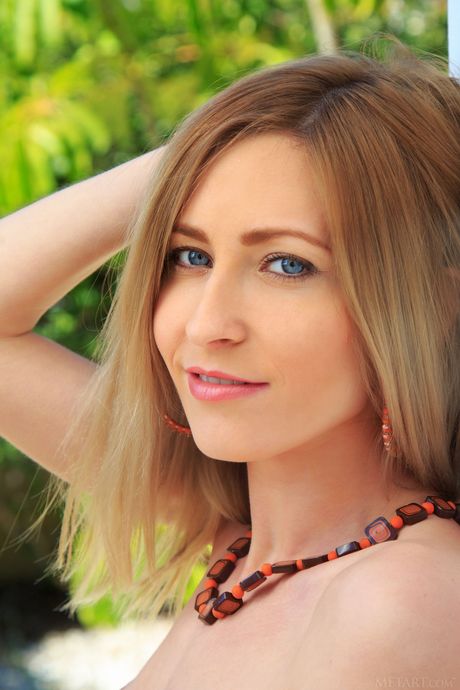 Blonde teen Janelle B models totally naked on a balcony with self-assuredness