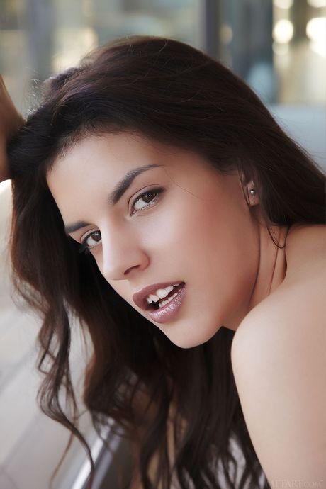 Engaging teen Candice Luka removes her lingerie and heels to pose nude