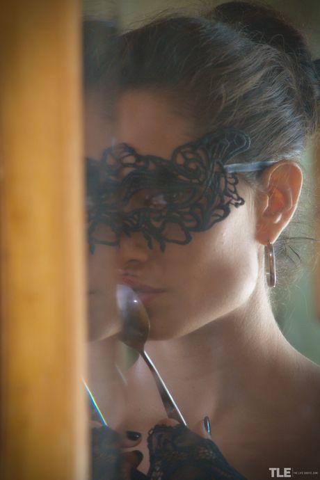 Sexy Latina Solange removes her mask and lingerie to pose nude in a dining room