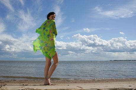 Petite teen Anais highlights her tight ass while naked on a sandy beach