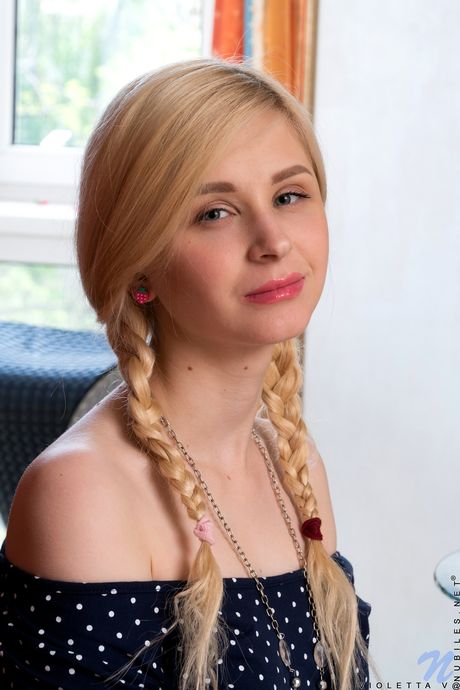 Blonde girl Violetta V removes a hat and heels before showing her pink pussy