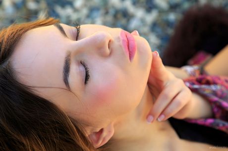 Natural redhead Debora A models totally naked in a garden setting