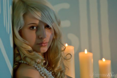 Blonde teen Eyra U gets naked in a pair of knee socks during a solo gig