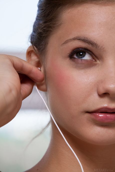 Ukrainian lady Emma Sweet removes her lingerie and poses nude on a bed