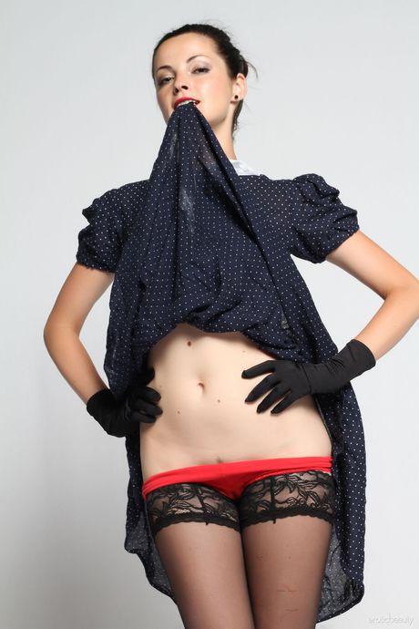 Gorgeous teen Lu Lu removes black gloves and stockings to pose nude in heels