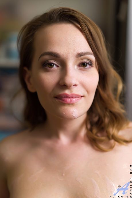 Mature brunette Alika S shows her tits and rubs ice cream on her pussy