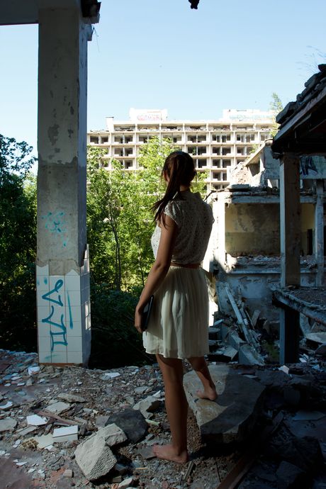 Brunette babe Lorette strips outdoors and masturbates her shaved pussy