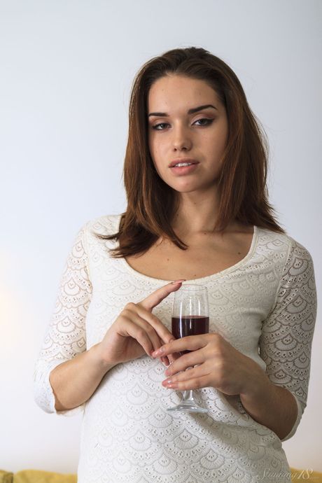 Barely legal girl Aza strips off on a bed in a confident fashion