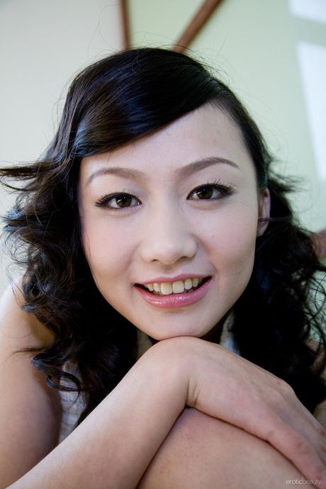 Solo girl Mellenney removes a black dress to pose nude in high heels