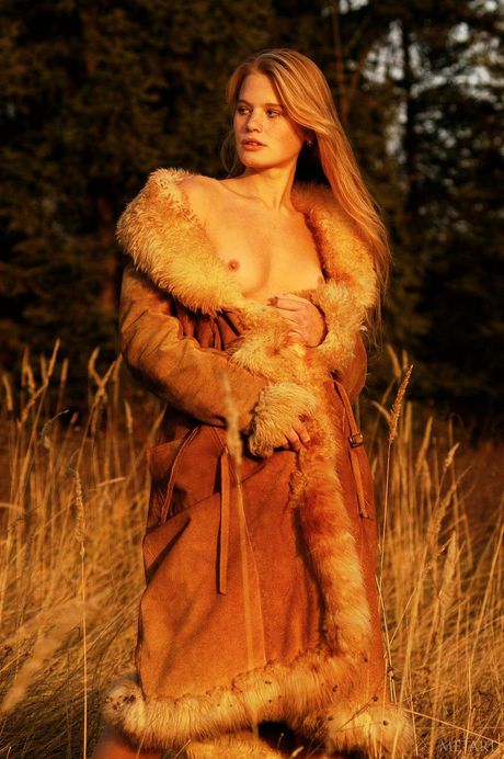 Met Art: Ligh-haired teen Andrea C poses nude in a fur coat and heels on a lawn