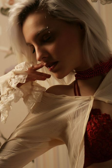 Blonde teen Kira W removes her lingerie to pose nude in candlelight