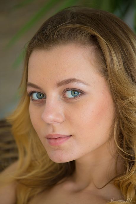 Petite teen Agnes uncovers her big tits as she gets naked in a kitchen