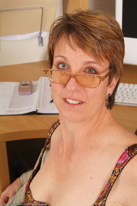 Mature secretary Embers shows her big ass and bush at work