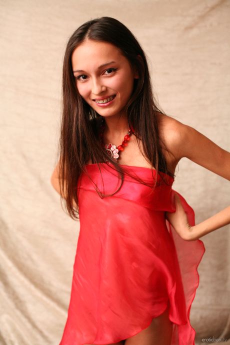 Slender teen Sveta H works free of her clothes to model in the nude