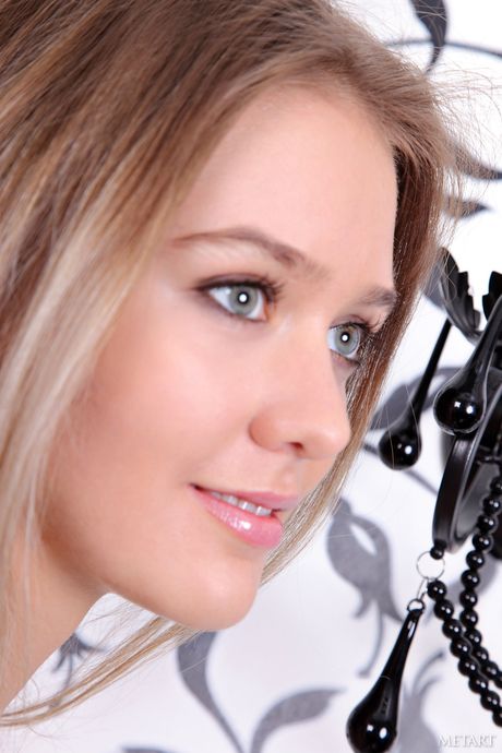 Svelte teen Sara B displays her big tits and poses naked