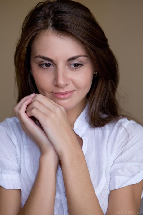 Brunette teen Astrud A takes off everything on a chair in a sexy manner