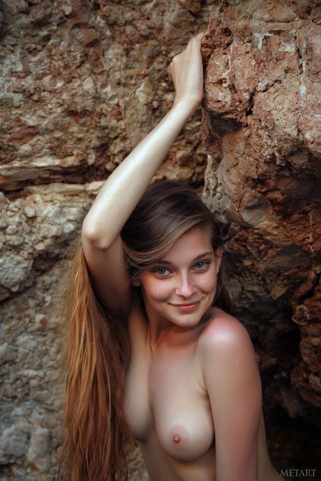 Glamorous redhead Indiana A reveals her big tits and poses naked on the beach