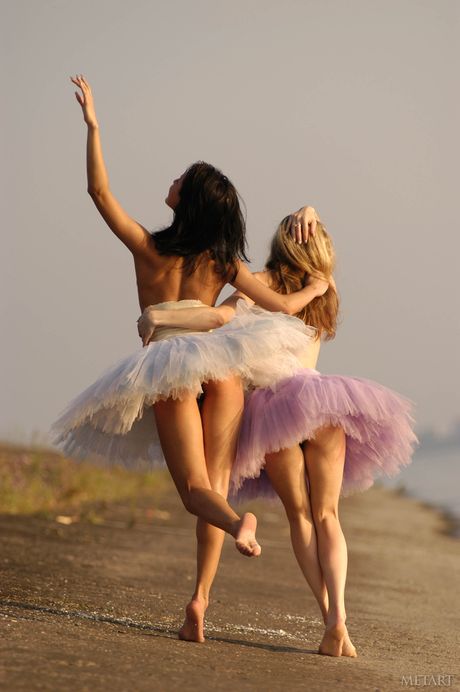 Flexible ballerina strips naked in the rain and poses in the nude