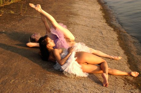 Flexible ballerina strips naked in the rain and poses in the nude
