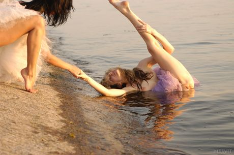 Flexible ballerina strips naked in the rain and poses in the nude