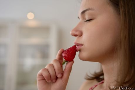 Adorable teen Yenn Cat gets naked on a kitchen counter while eating strawberries