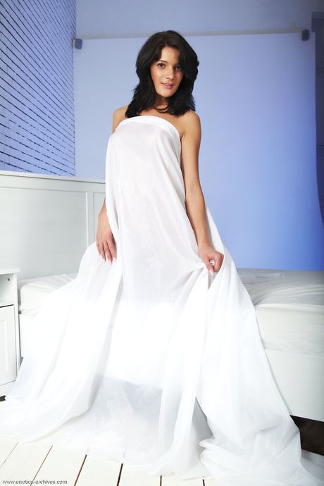 Leggy teen Judi strikes confident nude poses on a bed during solo action