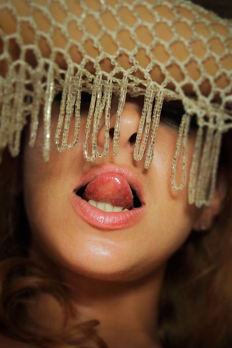 Young redhead Vetta fingers her pussy while naked on a bed