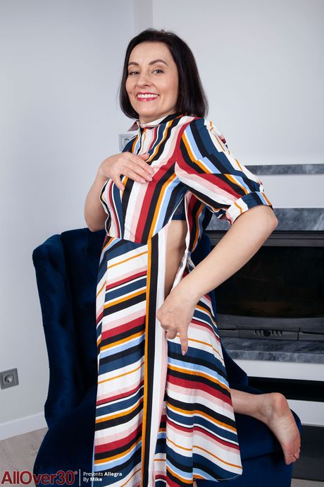 Mature housewife Allegra shows her big tits and spreads her hairy muff