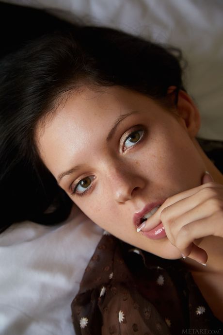 Delicate teen Anie Darling removes a sheer top to pose nude on her bed