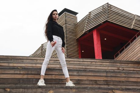 Leona Mia removes her dress and poses nude on her bed