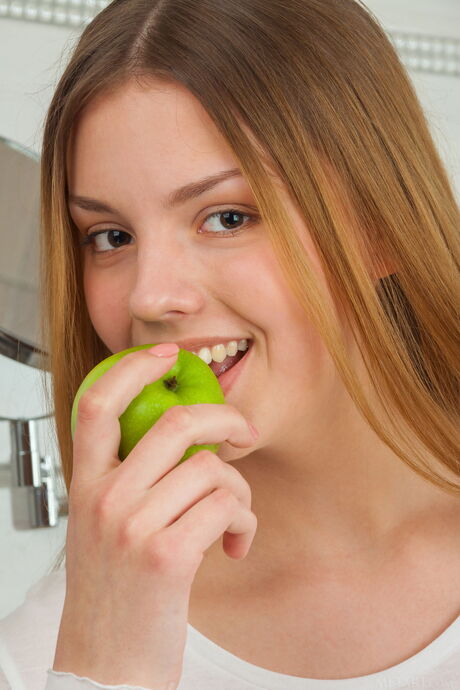 Delicate teen Ledina shows her small tits and poses naked