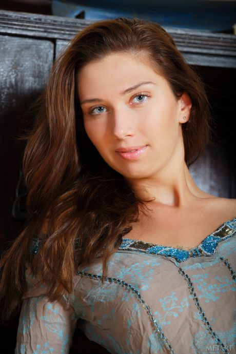 Thin teen Zhanna B gets naked and exhibits her big tits and bald pussy