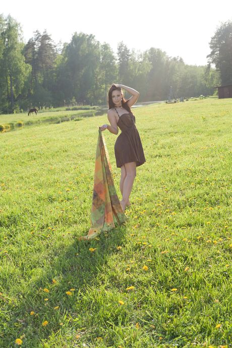 Sexy brunette Karina N in short dress showing off big tits & bald pussy in field