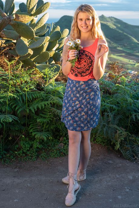 Young blonde Casey gets naked on a seaside cliff by herself