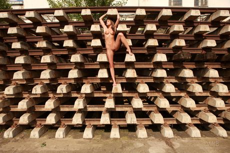 Hot teen Little Caprice strikes great nude poses on a backyard patio