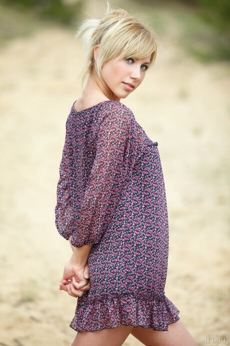 Blonde teen Sofia F strips down on a patio chair in the nude