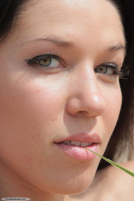 Sabinna shows her big tits and sexy feet on the beach