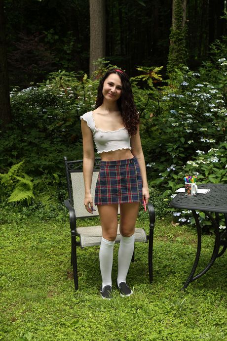 Petite teen Liz Jordan gets naked in a pair of socks and a uniform