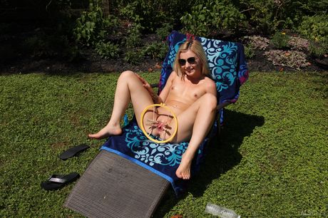 Blonde teen Minxx Marii gets naked before pissing on a backyard patio