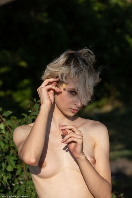 Skinny blonde teen Azshara strips down in a backyard by herself