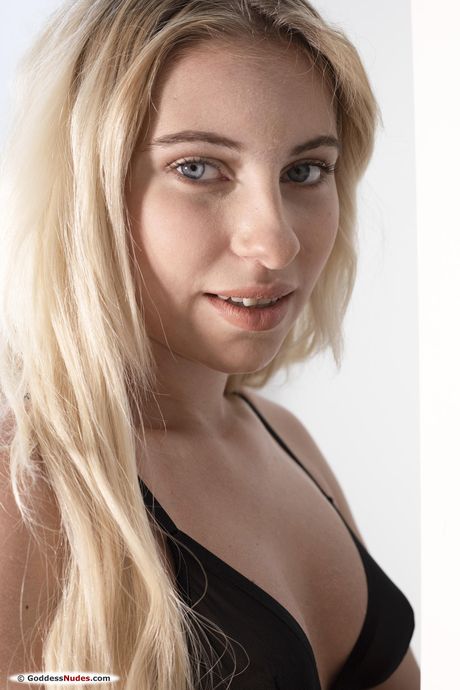 Lilly Bella takes off her lingerie and poses naked on the bed