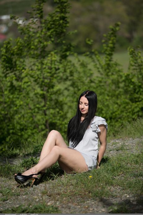 Veronica Snezna climbs a hill behind town to model in the nude