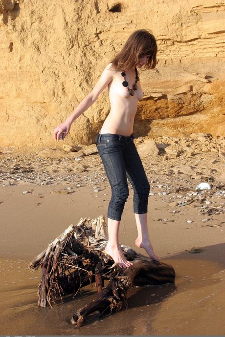 Svelte teen Lusi A gets naked in the water and on the sand