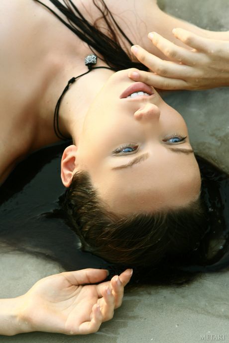 Lean teen Nadya C strips her dress & poses nude on the sandy beach