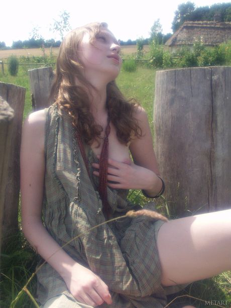 Lean teen Katya B strips naked & poses in the middle of a field