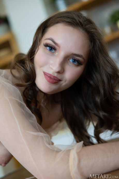 Russian cutie Viviann removes her clothes and poses naked in the kitchen