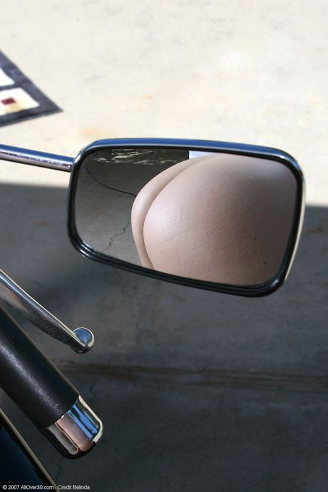 Mature blonde Andie shows her big ass and poses in her lingerie outdoors